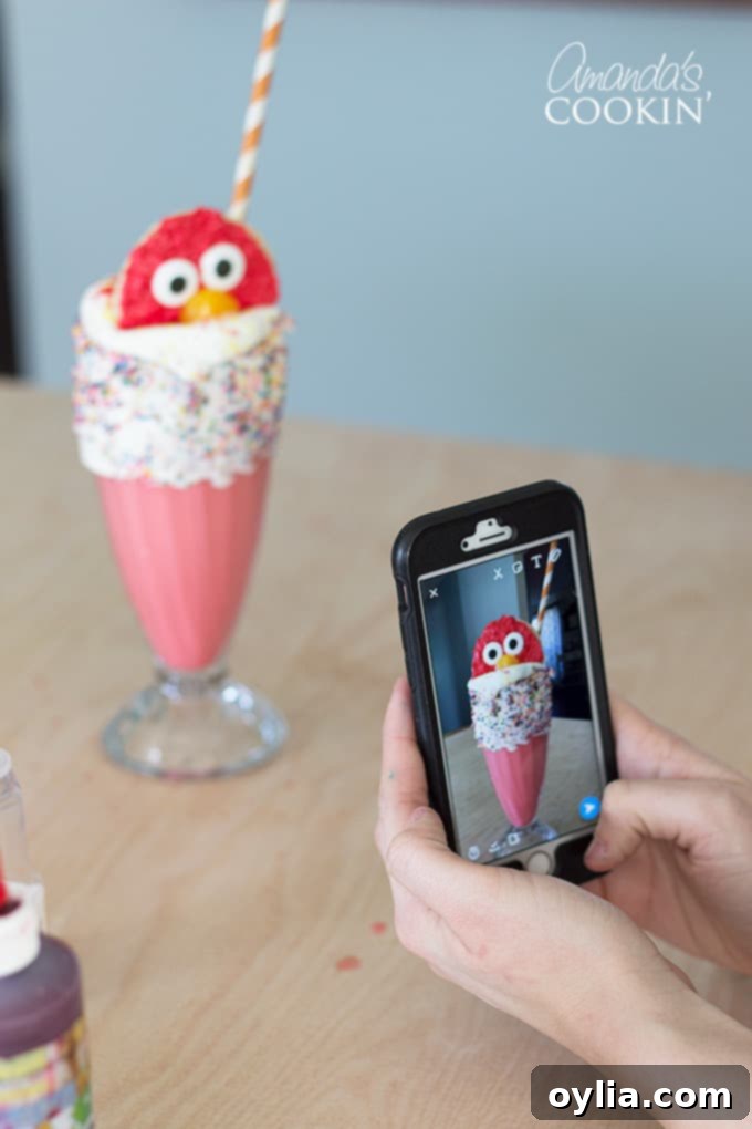 A picture being taken of the completed Elmo Freakshakes, showcasing their appeal.