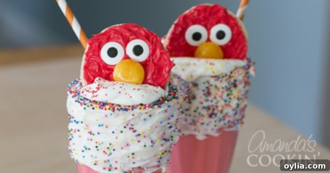 Elmo cookies resting perfectly on top of a whipped cream-adorned milkshake, ready to be enjoyed.