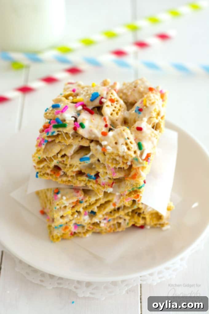 A stack of three soft and chewy Funfetti Marshmallow Cereal Bars, showcasing their thickness and colorful sprinkles.
