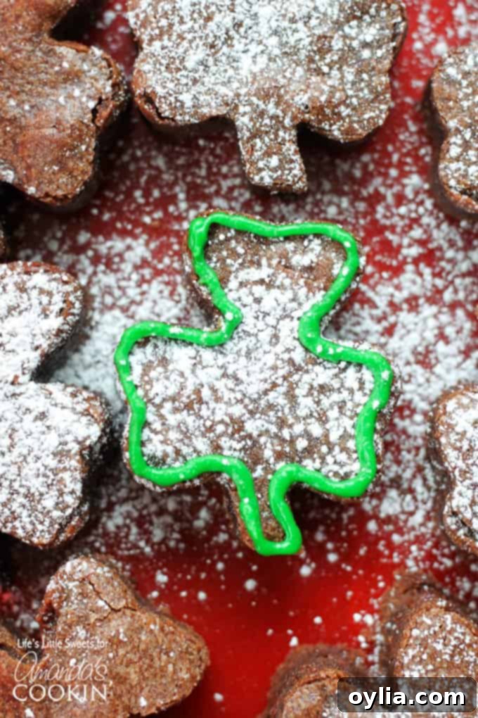 Fudgy shamrock shaped brownie on a white plate, ready for St. Patrick's Day