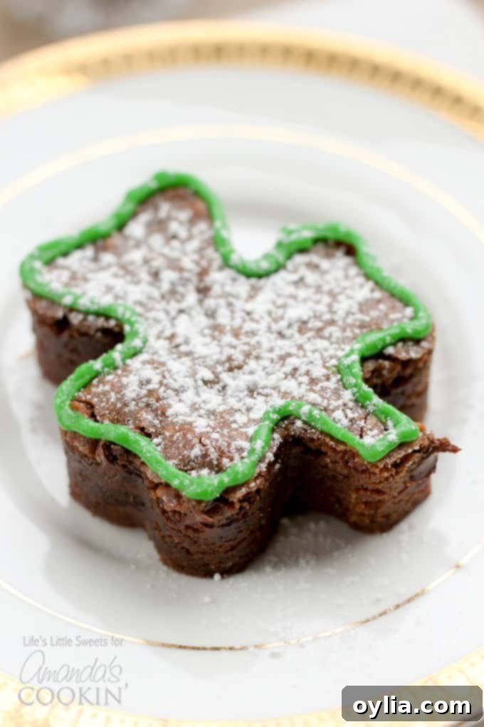A stack of beautifully decorated shamrock shaped brownies for St. Patrick's Day