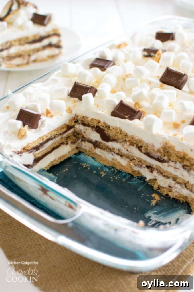 sliced s'mores icebox cake in a glass pan, showing the distinct layers