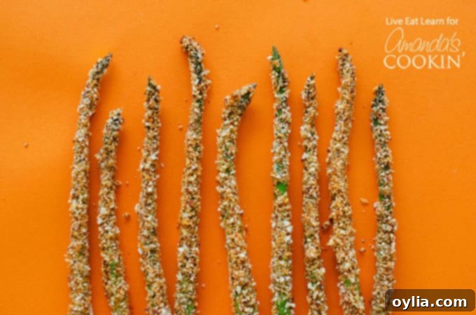 We hope you enjoy these crispy Asparagus Fries! A close-up of the delicious, golden-brown fries on a serving platter.