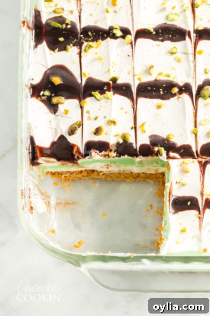 pistachio pudding dessert with a slice out of it