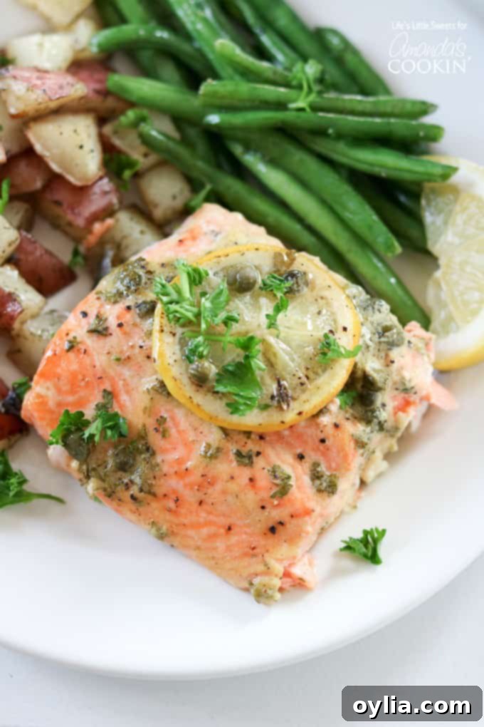 Red potatoes, green beans and dijon caper salmon served on a plate