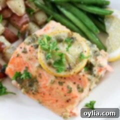 Zesty Lemon Caper Salmon 11 A close up of a salmon on plate