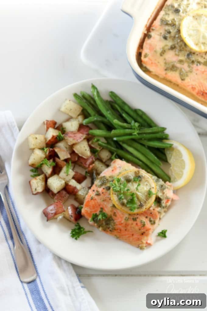 A plate of salmon with potatoes and green beans