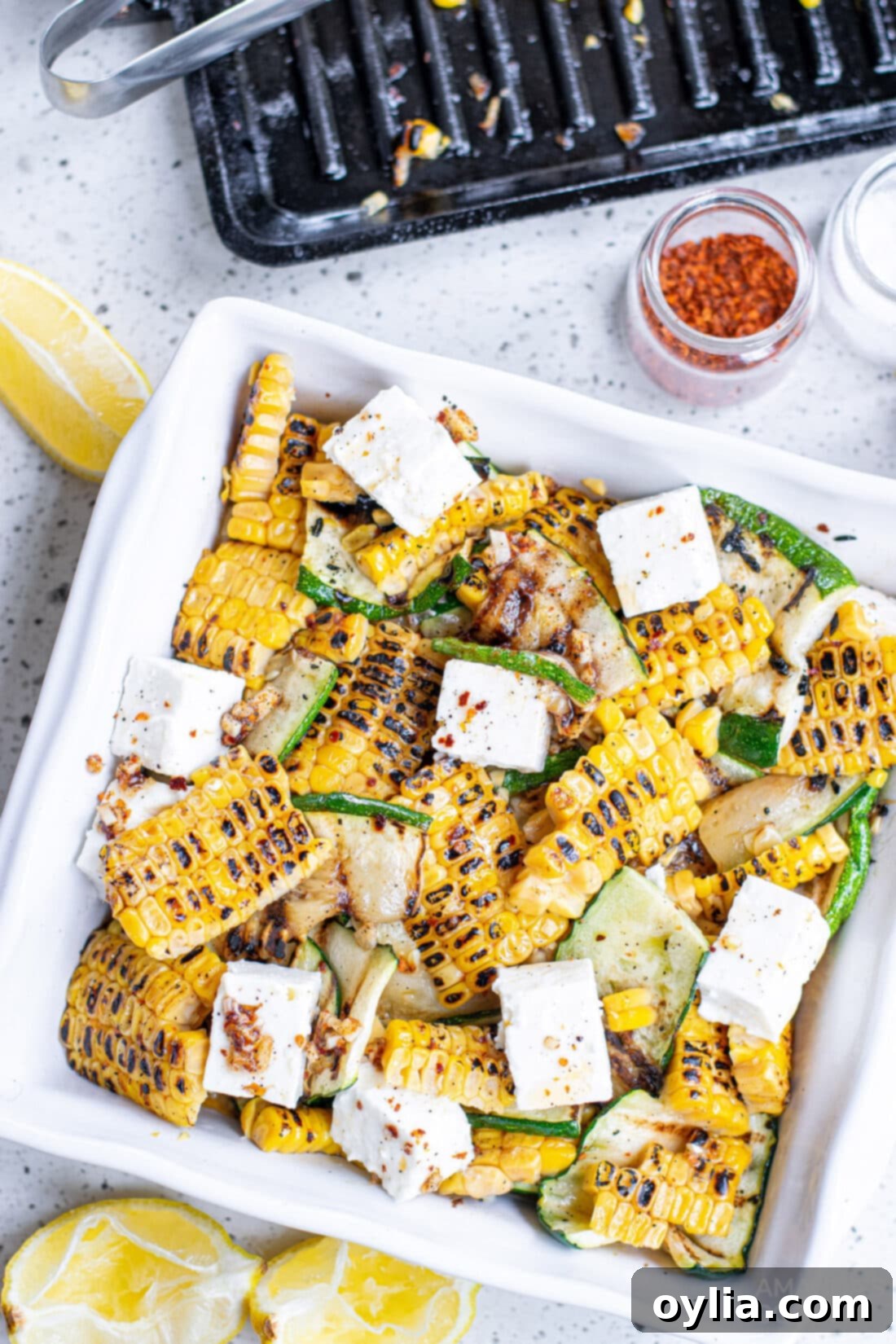 Grilled Corn & Zucchini Salad in a bowl, showcasing fresh char-grilled vegetables, feta, and lemon