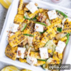 Grilled Corn & Zucchini Salad with Feta served in a white bowl, ready to eat