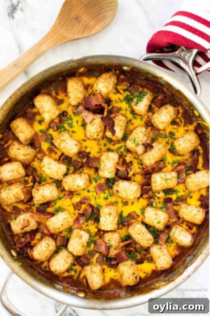 overhead shot of bbq chicken tater tot skillet, garnished with fresh parsley