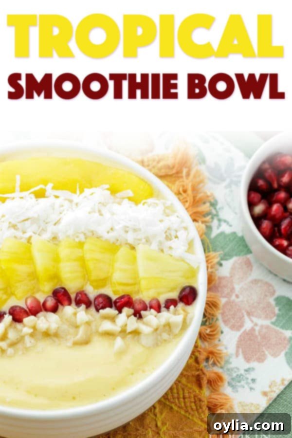 Pin-worthy image of a delicious Tropical Smoothie Bowl, showcasing its vibrant colors and healthy toppings like mango, pineapple, coconut, and pomegranate.
