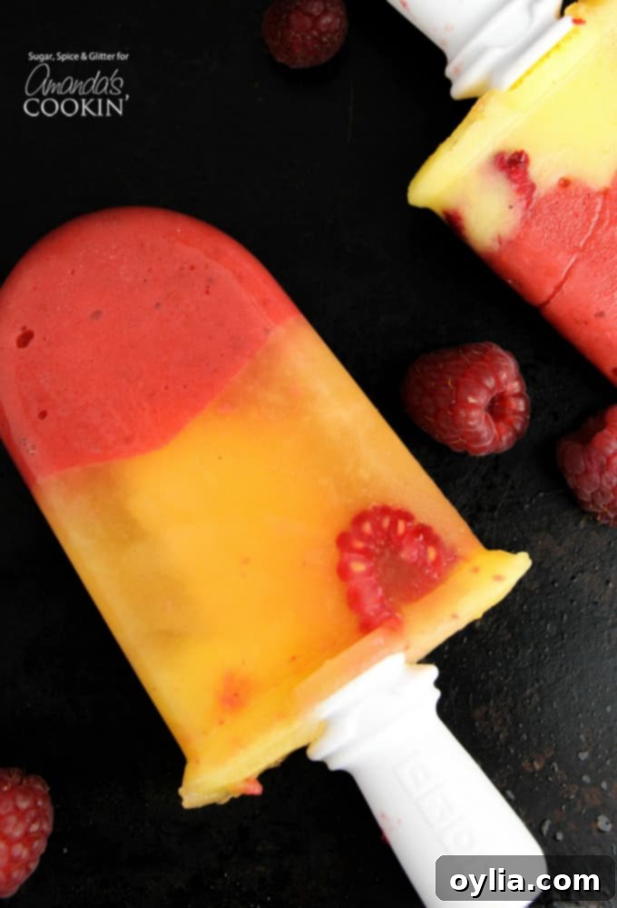 Adult friendly vodka and limoncello infused mango raspberry popsicles