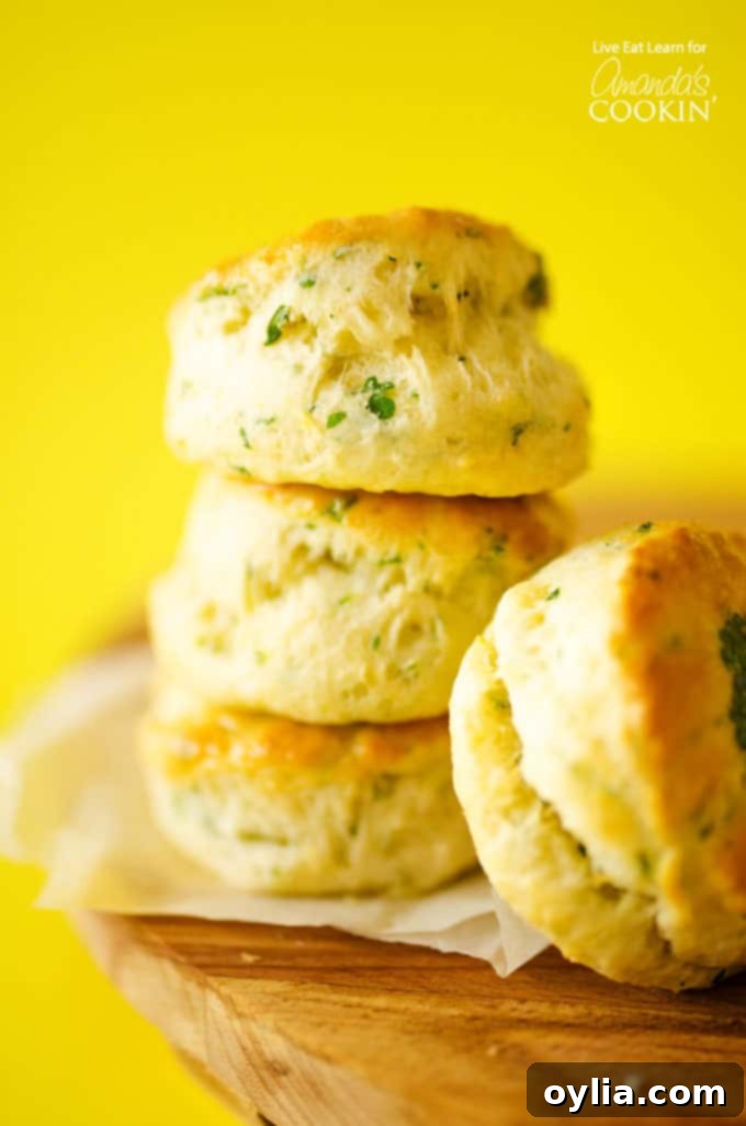 Stacked flaky buttermilk biscuits with fresh herbs
