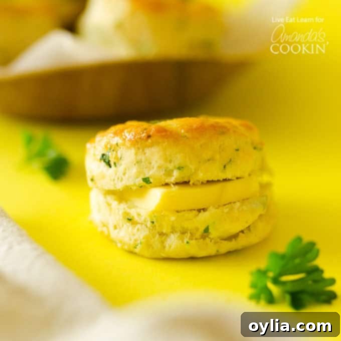 Close-up of a homemade biscuit with a pat of butter melting into its flaky layers