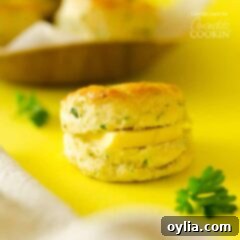 Close-up of a homemade biscuit with a pat of butter melting into its flaky layers