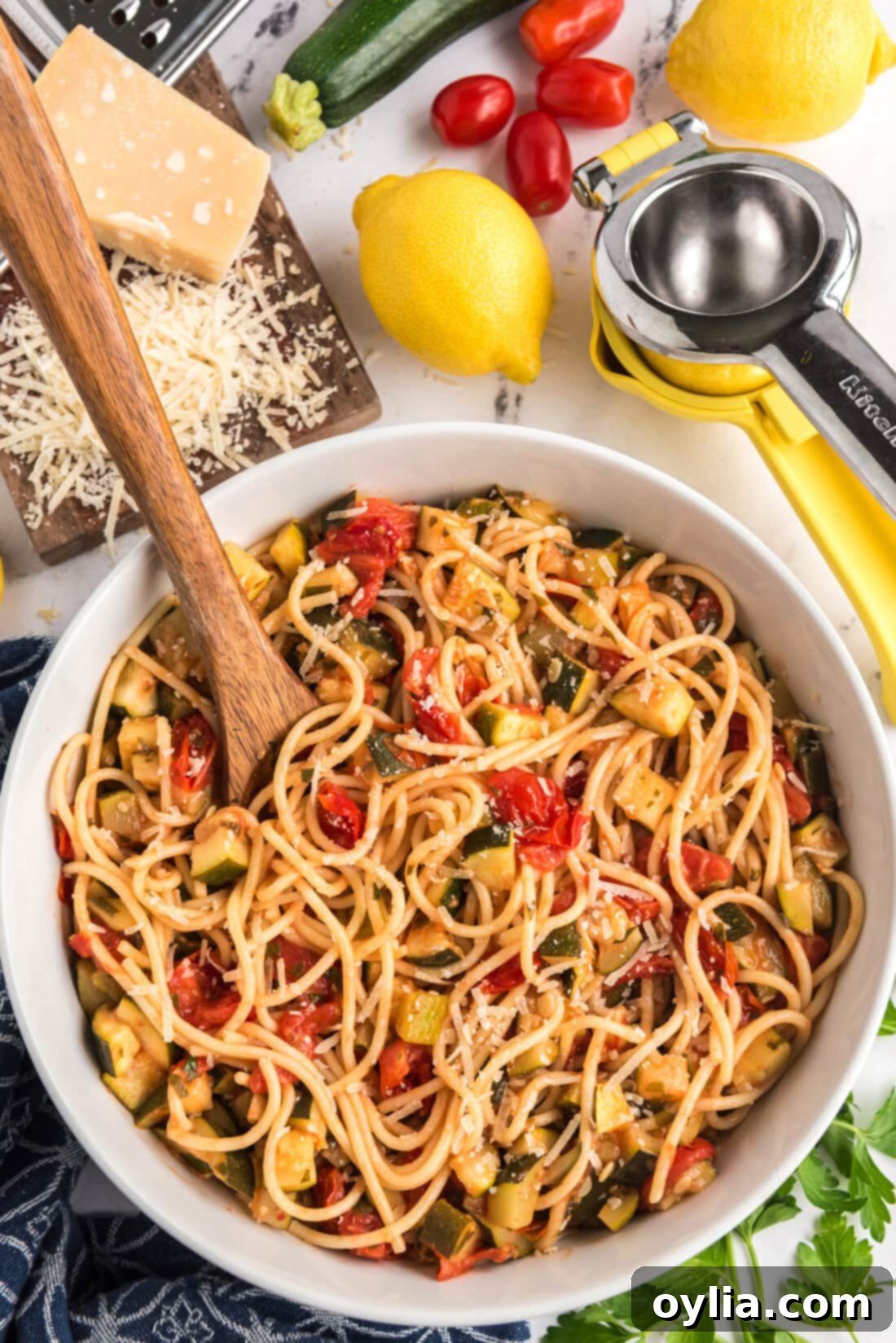 Bowl of Simple Zucchini Tomato Pasta with a spoon in it, ready to be enjoyed