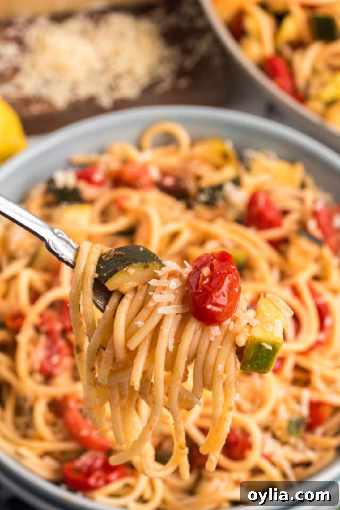 Simple Zucchini Tomato Pasta twisted on a fork, showing the vibrant vegetables and noodles