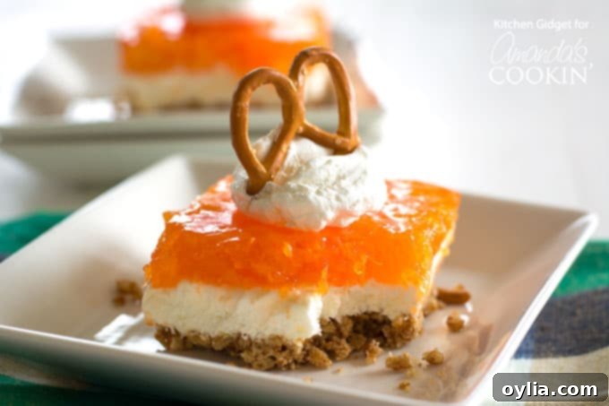Mandarin Orange Pretzel Salad Recipe - A delightful layered dessert with a pretzel crust, cream cheese, and orange jello.