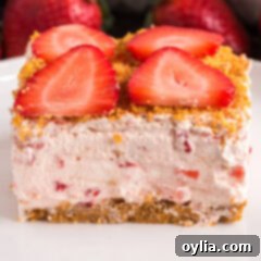 Close up photo of a slice of Strawberry Dream Dessert with a fork
