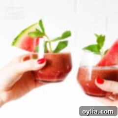 women clinking glasses of watermelon smoothies