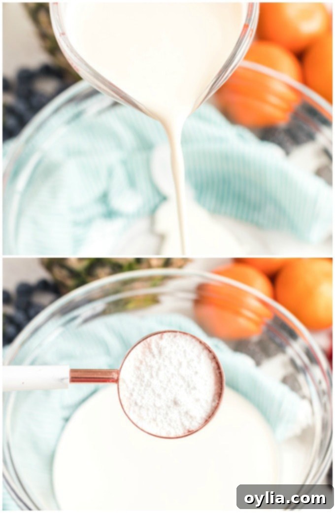 An electric hand mixer actively whipping heavy cream in a stainless steel bowl, showing the cream beginning to thicken and form soft peaks, indicating it's on its way to becoming fluffy whipped cream.