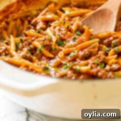 pan of sloppy joe pasta with a wooden spoon
