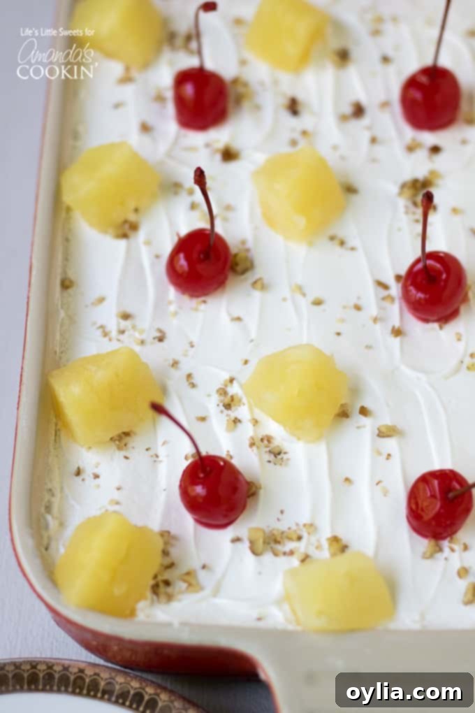 Banana Split Dessert Recipe with pineapple and cherry topping and layered view