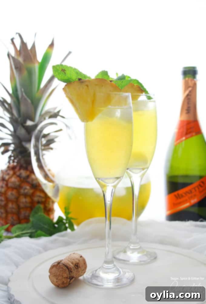 flutes with pineapple prosecco punch and pineapple garnish