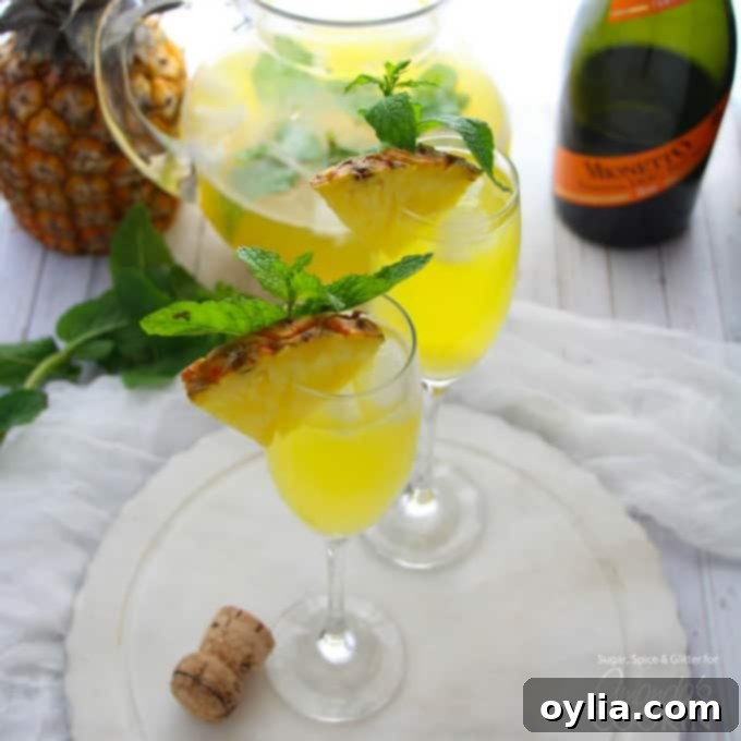 Pineapple Prosecco Punch in champagne flutes