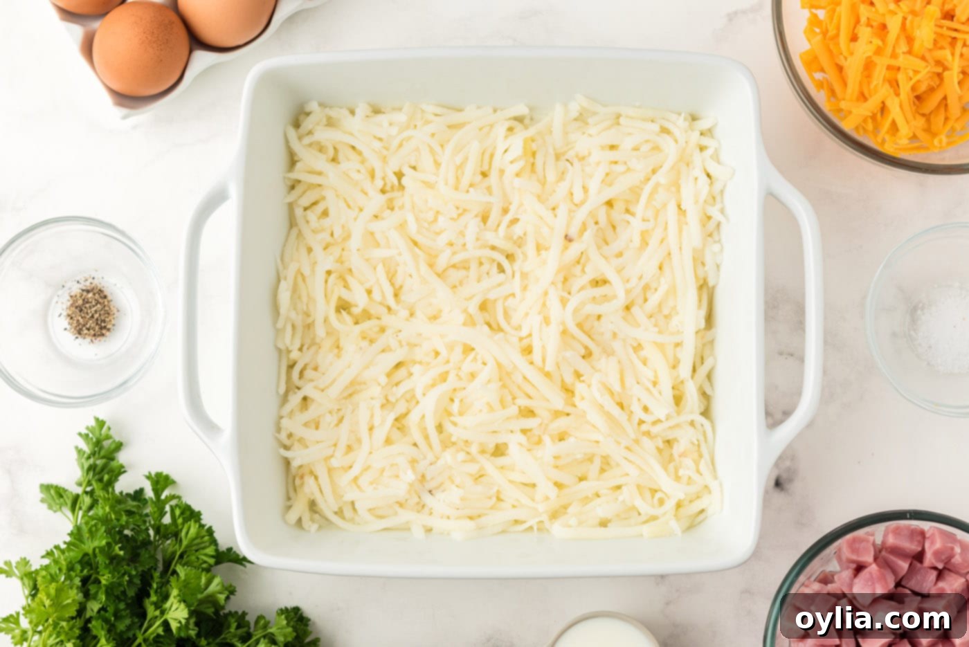 Hash browns forming the base layer in a baking dish