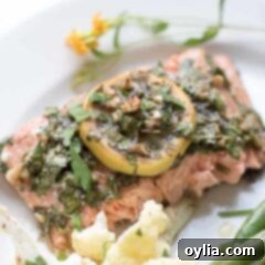 salmon on a plate with lemon garnish