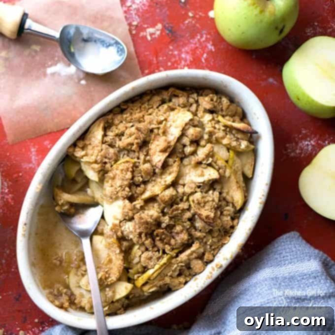 Apple crisp in a serving dish with a spoon