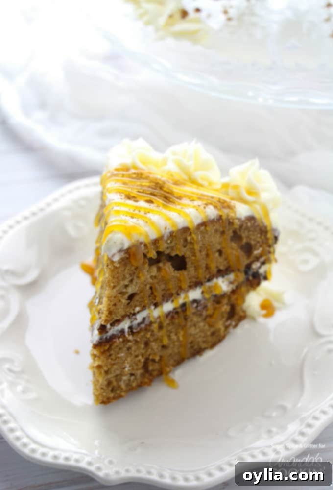 Close-up of a perfectly sliced spice cake, revealing its moist crumb, multiple layers, and thick cream cheese frosting. A caramel drizzle adds an extra touch of decadence.