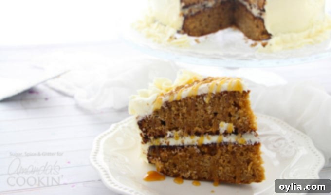 Close-up of a slice of spice cake, perfectly moist with creamy frosting, served on a white plate. A perfect representation of fall dessert perfection.
