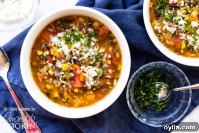 A serving of vegetable rice soup in a rustic ceramic bowl, garnished