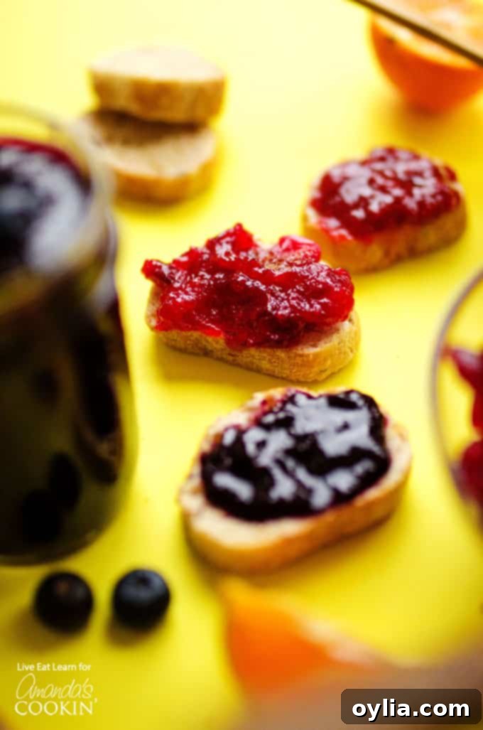 Delicious homemade berry jam in three jars, perfect for toast or desserts.