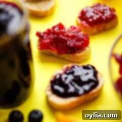 Toast topped with generous dollops of homemade berry jam, showcasing its appealing texture.