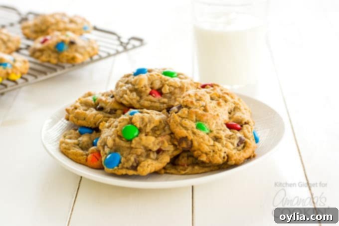 Monster cookies on a plate with a glass of milk