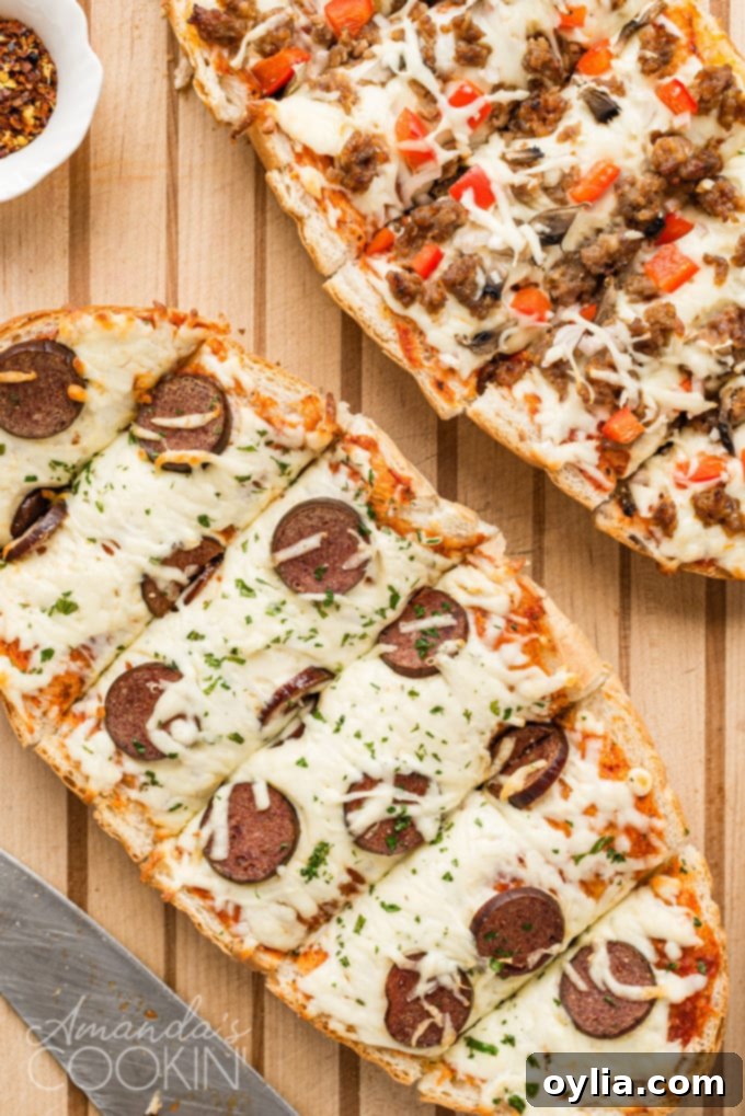 Overhead view of a whole French bread pizza, perfectly sliced on a rustic cutting board.