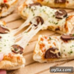 Stretched slices of pizza with cheese being pulled