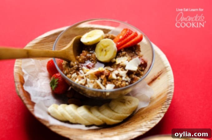 A beautifully presented bowl of breakfast quinoa with fresh fruit and a drizzle of honey
