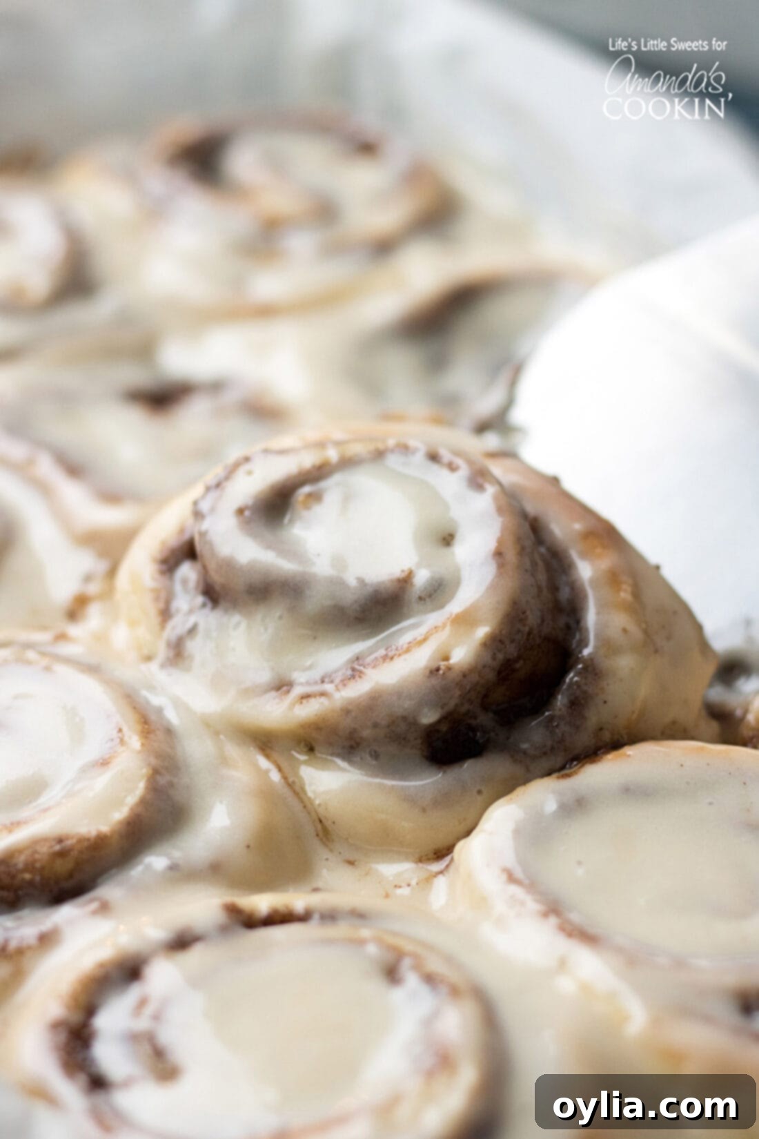 Homemade Cinnamon Roll being lifted out of the pan