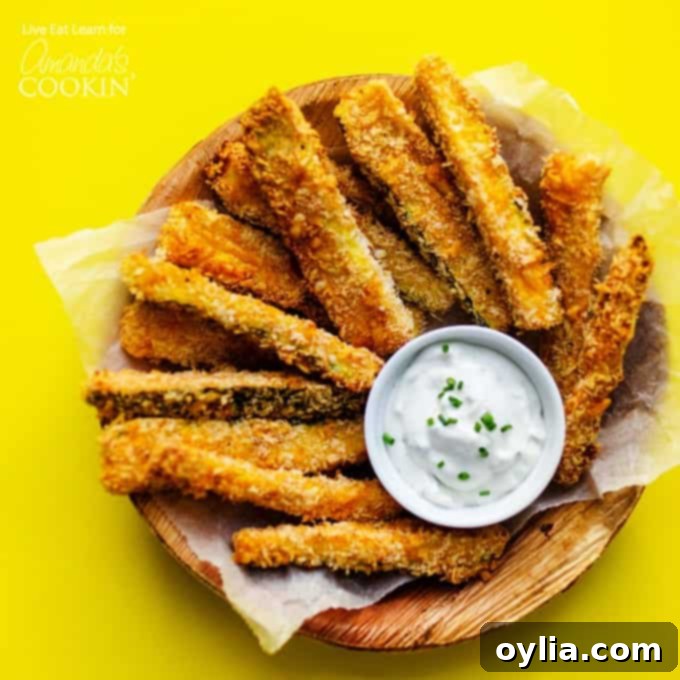 A beautifully arranged plate of golden-brown crispy zucchini fries, ready to be enjoyed as a healthy snack or side.