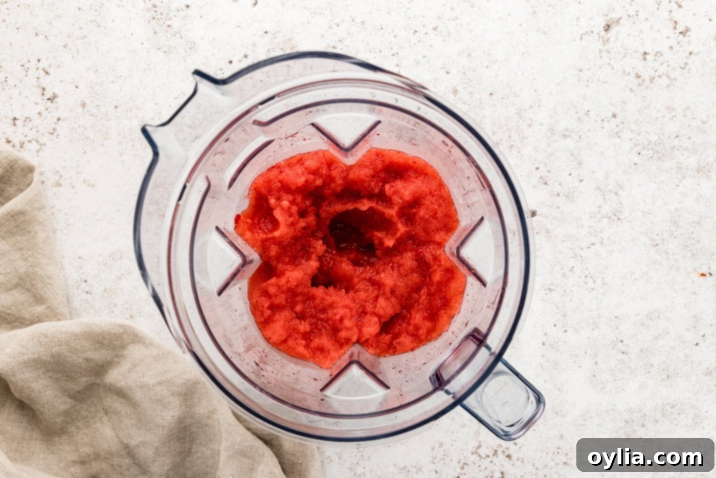 overhead of frozen strawberry margarita slush in a blender