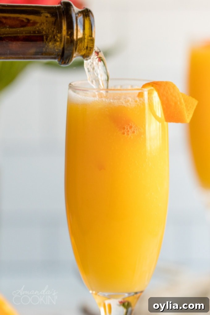 Pouring champagne into a flute, beginning to make a mimosa.
