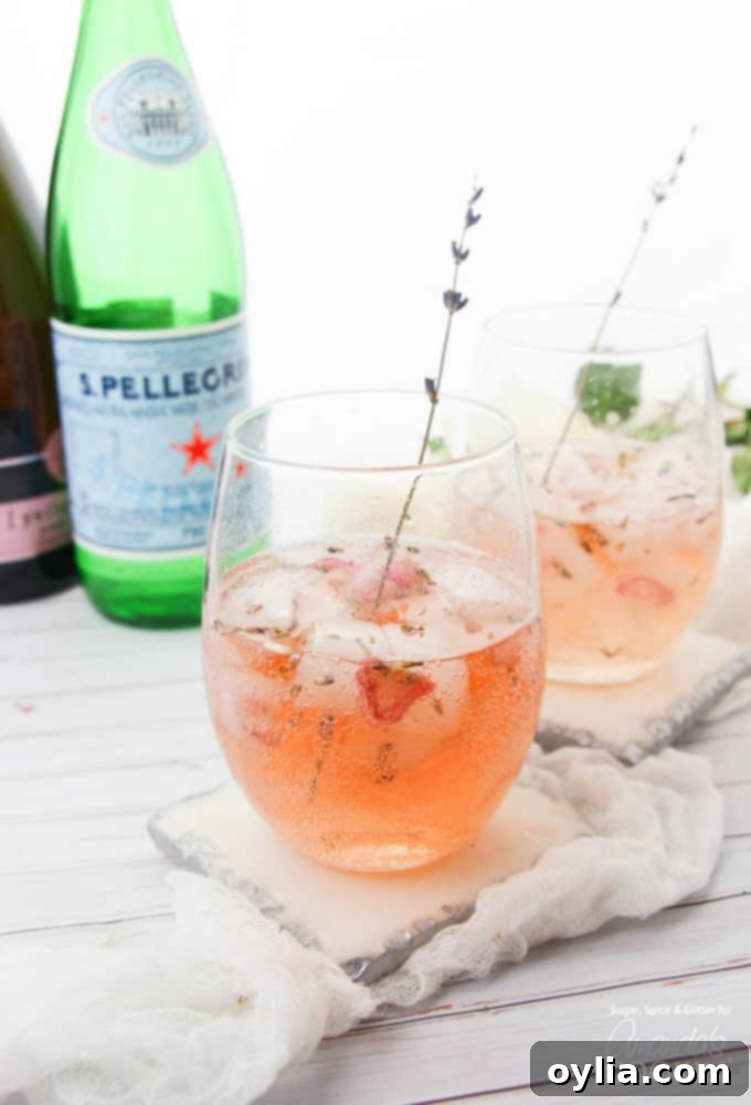 Lavender rose spritzer in wine glasses with lavender stem garnish