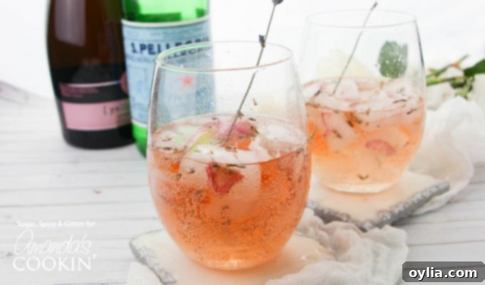 lavender rose spritzer in wine glass with lavender garnish