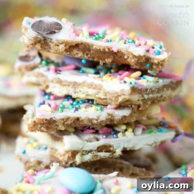 Stack of Easter-themed cracker toffee, showcasing layers of saltine, toffee, white chocolate, and colorful candy toppings.