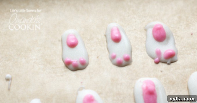 Finished white chocolate bunny feet with pink toe details, hardened and ready for assembly.