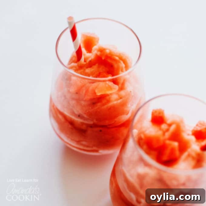 Watermelon slush with malibu served in a hurricane glass with lime wedge